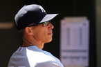 Manager Joe Girardi #28 of the New York Yankees watches from the dugout during the game against the Oakland Athletics