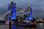 Spectators look at illuminations as they light up Tower Bridge in London on July 27, 2012, during the opening ceremony of the London 2012 Olympic Games.