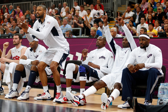 Tyson Chandler #4 and Kobe Bryant #10 of United States cheer on their teammates against France in the Men's Basketball Game on Day 2 of the London 2012 Olympic Games
