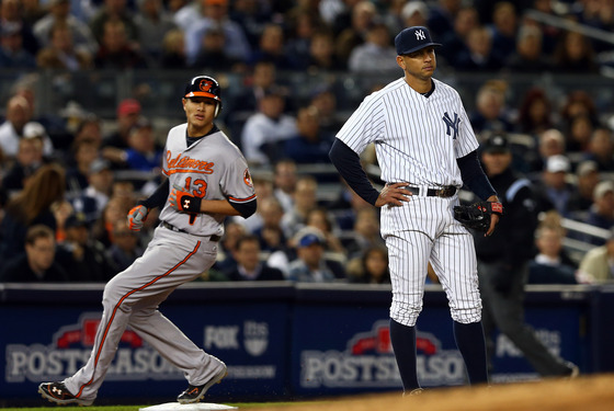 Alex Rodriguez #13 of the New York Yankees looks on as Manny Machado #13 of the Baltimore Orioles advances to third base on a double by Nate McLouth during Game Four of the American League Division Series at Yankee Stadium on October 11, 2012 in the Bronx borough of New York City.