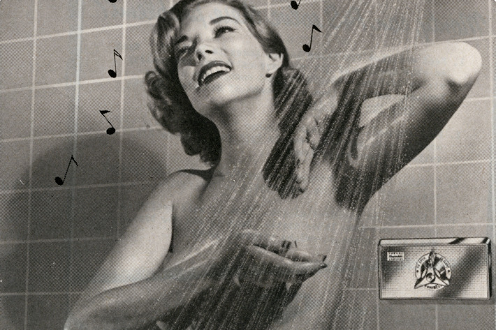 Retro woman showering, for The Strategist's review of a Thai all-natural deodorant spray.