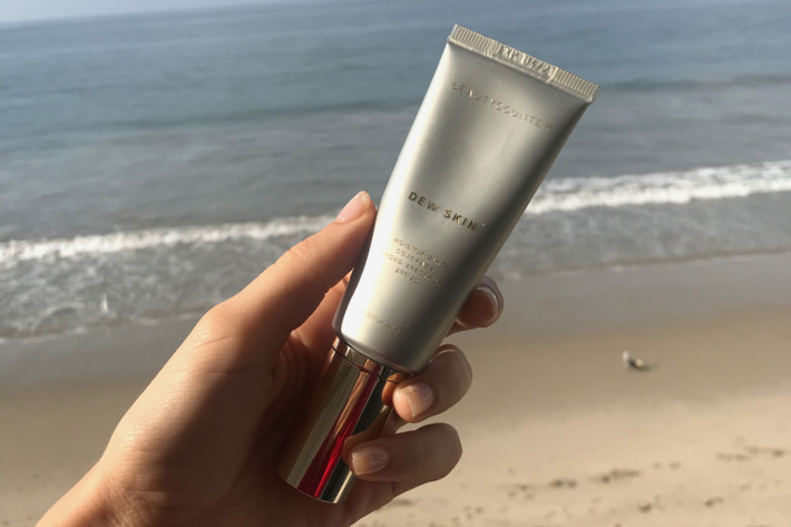Rio Viera Newton holding her Dew Skin up at the beach