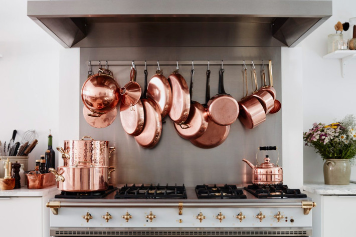 Copper pots hanging in the French kitchen of the Cook's Atelier in Paris — the Strategist reviews all the essentials needed to re-create a French kitchen.