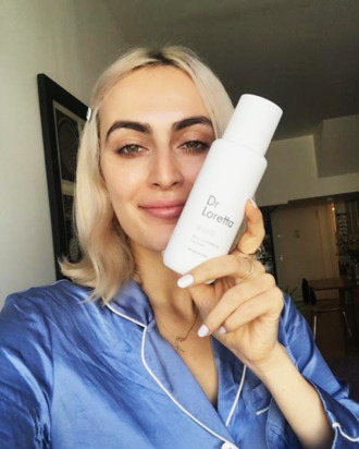 Rio Viera-Newton holding her Dr. Loretta cleanser.