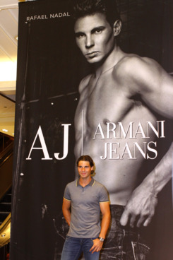 There has to be something awkward about standing in front of a giant shirtless picture of yourself, right?