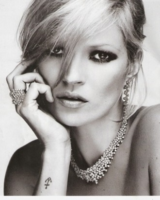 Kate Moss models her new jewelry.