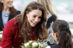 Kate winning over a potential voter with flowers.