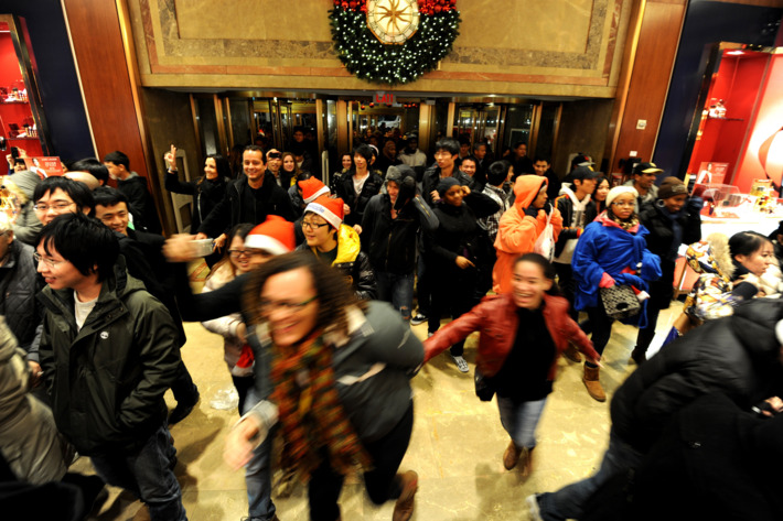 Oddly cheerful stampeding shoppers at Macy's on Black Friday.