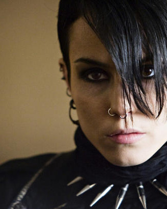 Noomi Rapace smiling for the camera as Lisbeth Salander.