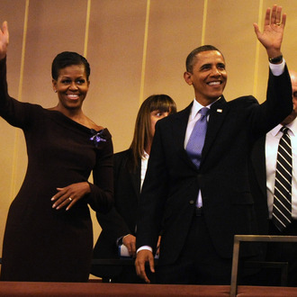 U.S. President Barack Obama and first lady Michelle Obama wave to guests as they arrive in their box at the Kennedy Center for the Performing Arts to attend the Let Freedom Ring Celebration on January 16, 2012 in Washington, DC.