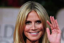 Model Heidi Klum poses on the red carpet for the 69th annual Golden Globe Awards at the Beverly Hilton Hotel in Beverly Hills, California, January 15, 2012.