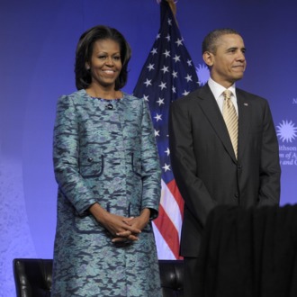 President Barack Obama and first lady Michelle Obama arrive to attend a groundbreaking ceremony at the construction site of the Smithsonian National Museum of African American History and Culture in Washington, Wednesday, Feb. 22, 2012.