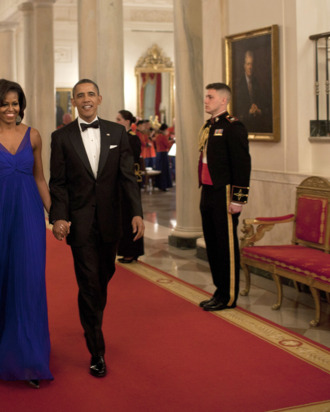 US President Barack Obama and first lady Michelle Obama walk through the Cross Hall to the East Room of the White House on February 29, 2012 in Washington. Obama and his wife Michelle hosted a dinner for members of the US armed forces who served in Iraq and Afghanistan. AFP PHOTO/Brendan SMIALOWSKI (Photo credit should read BRENDAN SMIALOWSKI/AFP/Getty Images)