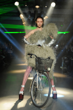 Dempsey Stewart biking through the Vivienne Westwood show.
