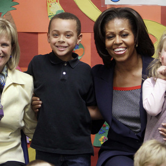 First lady Michelle Obama poses for a photo with New Hampshire's first lady, Dr. Susan Lynch and pre-schoolrs at the Penacook Community Center, Friday, March 9, 2012, in Concord, NH