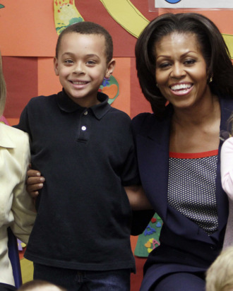 First lady Michelle Obama poses for a photo with New Hampshire's first lady, Dr. Susan Lynch and pre-schoolrs at the Penacook Community Center, Friday, March 9, 2012, in Concord, NH