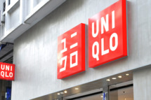 Shoppers walk past a branch of Japanese clothes retailer Uniqlo in Tokyo on October 8, 2010. The operator of Japan's cheap-chic clothing chain Uniqlo said it booked a higher annual net profit in the year to August but forecast it to slide 17 percent next year as competition stiffens