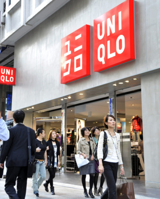 Shoppers walk past a branch of Japanese clothes retailer Uniqlo in Tokyo on October 8, 2010. The operator of Japan's cheap-chic clothing chain Uniqlo said it booked a higher annual net profit in the year to August but forecast it to slide 17 percent next year as competition stiffens