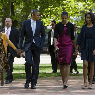 President Barack Obama, First Lady Michelle Obama and daughters Sasha and Malia walk across Lafayette Park to attend Easter Services at St. John's Episcopal Church on April 8, 2012 in Washington, D.C.