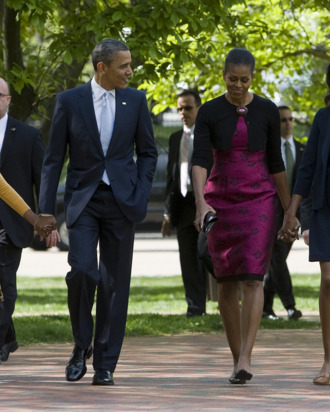 President Barack Obama, First Lady Michelle Obama and daughters Sasha and Malia walk across Lafayette Park to attend Easter Services at St. John's Episcopal Church on April 8, 2012 in Washington, D.C.