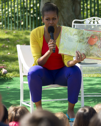 First Lady Michelle Obama reads a book to children during the 2012 White House Easter Egg Roll on the South Lawn of the White House in Washington, DC, April 9, 2012.
