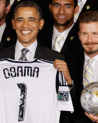 WASHINGTON, DC - MAY 15: U.S. President Barack Obama (L) poses for photographs with the Major League Soccer champions Los Angeles Galaxy and their mid-fielder David Beckham in the East Room of the White House May 15, 2012 in Washington, DC. Players from the Galaxy also participated in a