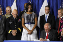 First lady Michelle Obama joined Illinois Gov. Pat Quinn, as he signed the Military Family Licensing Act into law Tuesday, June 26, 2012, at the Illinois National Guard Armory in the South Loop in Chicago, Illinois.
