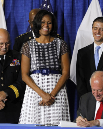 First lady Michelle Obama joined Illinois Gov. Pat Quinn, as he signed the Military Family Licensing Act into law Tuesday, June 26, 2012, at the Illinois National Guard Armory in the South Loop in Chicago, Illinois.