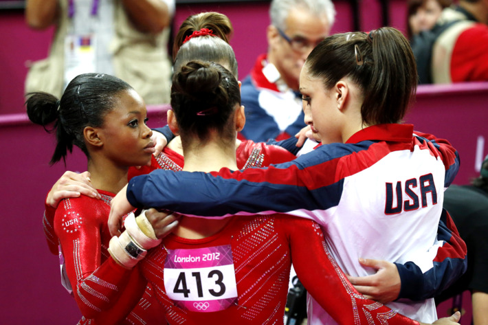 US gymnast Alexandra Raisman (C) and teammates react during the women's team final of the artistic gymnastics event of the London Olympic Games on July 31, 2012 at the 02 North Greenwich Arena in London.