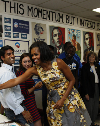 First lady Michelle Obama greets volunteers during a visit to a campaign field office during a visit in Raleigh, N.C., Wednesday, Aug. 1, 2012.