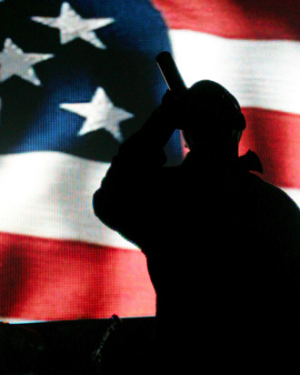 LAS VEGAS - DECEMBER 29: Rap artist Jay-Z is silhouetted against a video image of an American flag as he performs during a sold-out show at The Pearl concert theater at the Palms Casino Resort December 29, 2007 in Las Vegas, Nevada. (Photo by Ethan Miller/Getty Images)