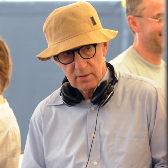 US film director Woody Allen (R) stands near US actor Jesse Eisenberg (L) and Canadian actress Ellen Page on the set of 'Bop Decameron', the cult filmmaker's latest production, at Campo de' Fiori square in central Rome, on July 28, 2011. The film's crew has been spotted everywhere from the Spanish Steps to the Colosseum to Rome's main shopping avenue, Via del Corso, and paparazzi have been kept busy chasing stars Alec Baldwin and Penelope Cruz. AFP PHOTO / TIZIANA FABI (Photo credit should read TIZIANA FABI/AFP/Getty Images)