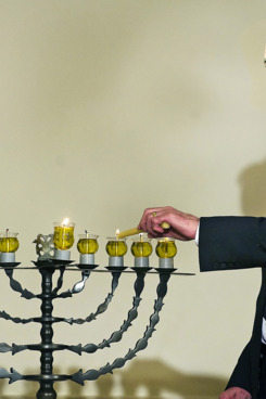 David Ben-Gurion's grandson Yariv Ben-Eliezer lights the Menorah during the Hanukkah reception at White House in Washington, DC, December 15, 2008. AFP PHOTO/Jim WATSON (Photo credit should read JIM WATSON/AFP/Getty Images)
