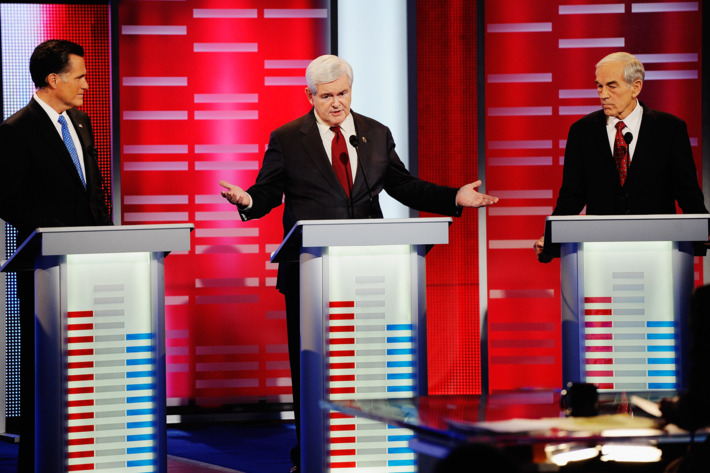 DES MOINES, IA - DECEMBER 10: Former speaker of the House Newt Gingrich (C) speaks while former Massachusetts Gov. Mitt Romney (L) and U.S. Rep. Ron Paul (R-TX) look on during th ABC News GOP Presidential debate on the campus of Drake University on December 10, 2011 in Des Moines, Iowa. Rivals were expected to target front runner Gingrich in the debate hosted by ABC News, Yahoo News, WOI-TV, The Des Moines Register and the Iowa GOP. (Photo by Kevork Djansezian/Getty Images)