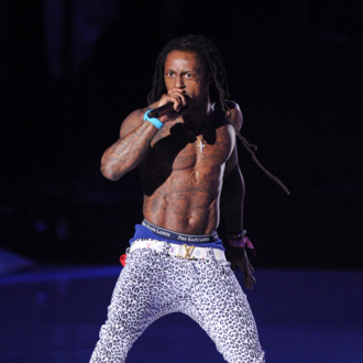 LOS ANGELES, CA - AUGUST 28: Rapper Lil Wayne performs onstage during the 2011 MTV Video Music Awards at Nokia Theatre L.A. LIVE on August 28, 2011 in Los Angeles, California. (Photo by Kevin Winter/Getty Images)