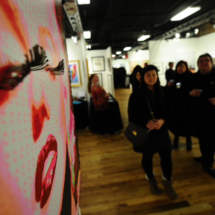 Visitors walks through the Red Dot Art Fair and the Korean Art Show, in New York, March 3, 2011. New York kicked off its annual art week with shows and art fairs throughout the city such as The Armory Show, Fountain , Red Dot, Volta NY, and Pulse amongst others , are expected to draw more than 60,000 attendees and generate more than $40 million in economic activity in New York City. AFP PHOTO/Emmanuel Dunand (Photo credit should read EMMANUEL DUNAND/AFP/Getty Images)
