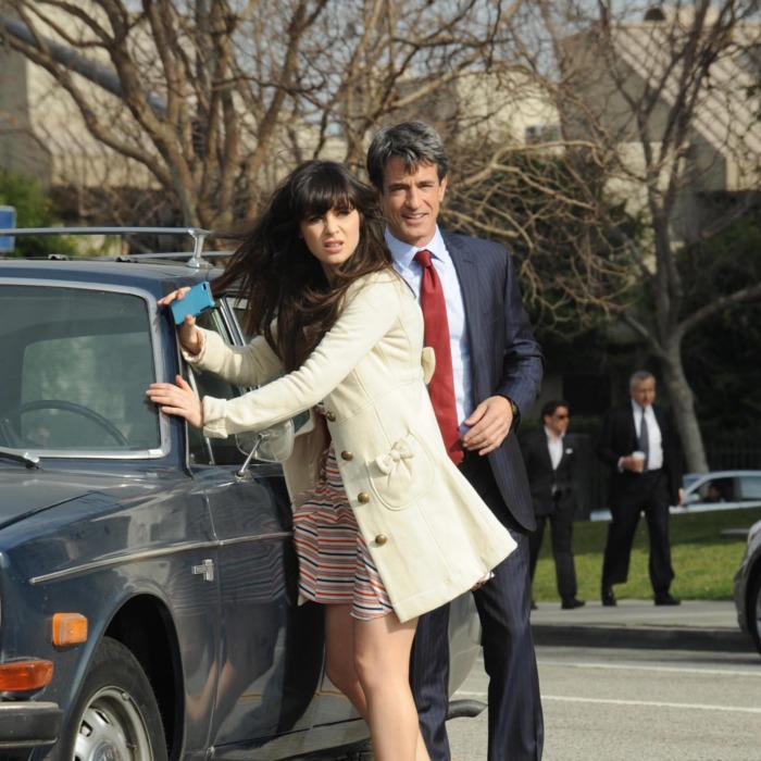 Russell (guest star Dermot Mulroney, R), the wealthy father of one of Jess' (Zooey Deschanel, L) students, helps her when her car breaks down.