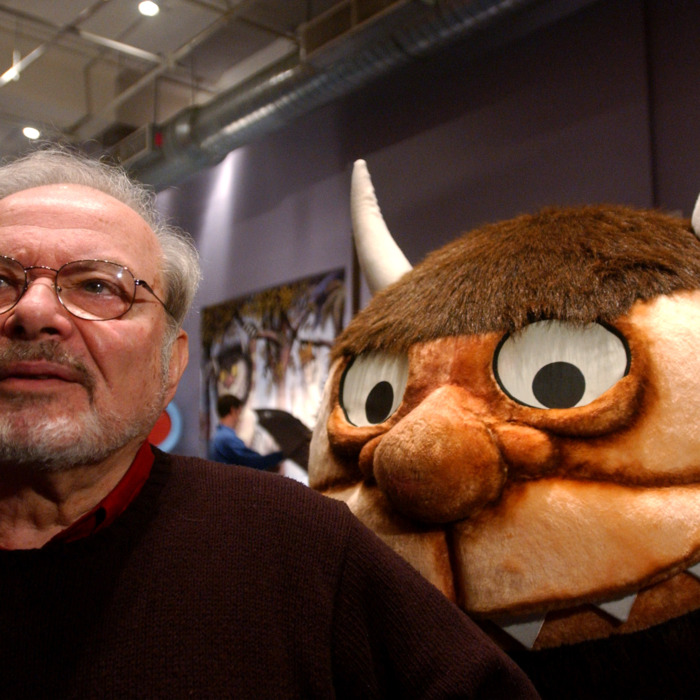 Standing with a character from his book
