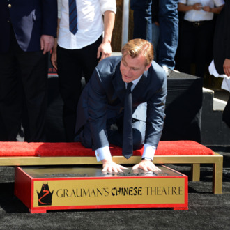 HOLLYWOOD, CA - JULY 07: Director, Writer, Producer Christopher Nolan, who was honored with Hand and Footprint Ceremony at Grauman's Chinese Theatre watched on by on July 7, 2012 in Hollywood, California. (Photo by Frazer Harrison/Getty Images)
