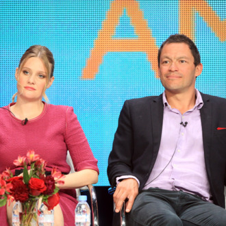 Actress Romola Garai (L) and actor Dominic West speak at the