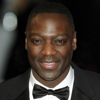 British actor Adewale Akinnuoye-Agbaje poses on the red carpet arriving at the BAFTA British Academy Film Awards at the Royal Opera House in London on February 12, 2012.