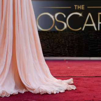 Antonella Michelena, a television reporter from Mexico, is silhouetted as she reports from the red carpet outside the Dolby Theatre in the Hollywood section of Los Angeles, Friday, Feb. 22, 2013 as preparations for this Sunday's 85th Academy Awards continue.