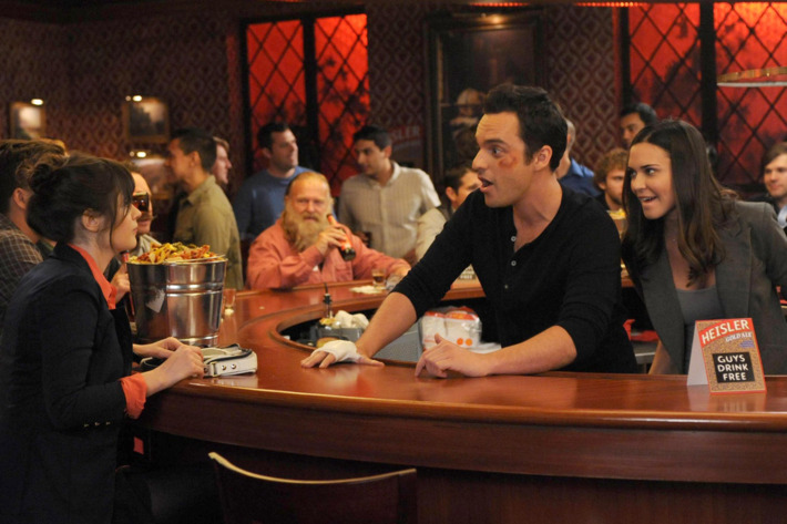 NEW GIRL: Jess (Zooey Deschanel, L) visits Nick (Jake Johnson, C) during his big marketing campaign to promote the bar and meets his beautiful boss (guest star Odette Annable, R) in the "Guys Night" episode of NEW GIRL airing Tuesday, March 12 (9:00-9:30 PM ET/PT) on FOX.