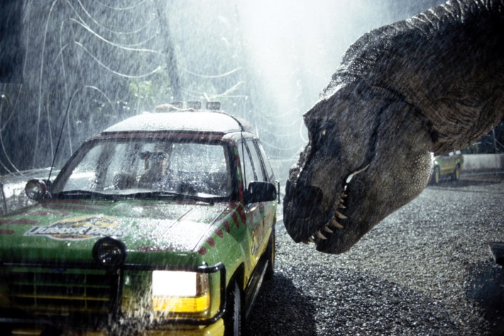A tyrannosaurus rex terrorizes people trapped in a car in a scene from the 1993 American film Jurassic Park directed by Steven Spielberg. The sci-fi adventure stars Sam Neill, Laura Dern, and Jeff Goldblum. The film is an adaptation of Michael Crichton's novel of the same name.
