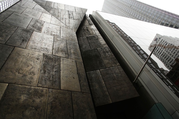 The former Museum of American Folk Art (L) stands next to the Museum of Modern Art (MoMA) on April 11, 2013 in New York City. MoMA announced yesterday that it will demolish the former Museum of American Folk Art, a building it purchased in 2011. The building, with a bronze sculptural facade, was architectonically acclaimed. MoMA says it needs to demolish the building in order to enlarge its own facilities.