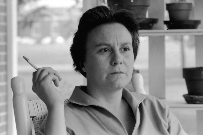 Author Harper Lee smoking cigarette on porch.