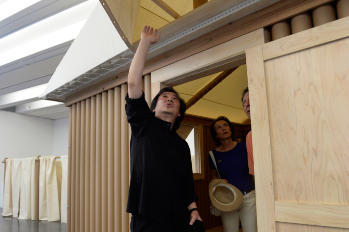 ASPEN, CO - AUGUST 2: Japanese architect Shigeru Ban, left, spends time with businessman and philanthropist Tom Pritzker, right, Pritzker's wife Margot, in Gallery 1 where has Shigeru Ban's humanitarian architecture on display. The Aspen Art Museum celebrates its grand opening to the public on Saturday, Aug. 2, 2014. The architect on the project, Shigeru Ban, was there for the celebration which included an official ribbon cutting and fireworks. (Photo by Kathryn Scott Osler/The Denver Post via Getty Images)