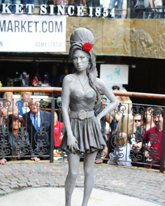 LONDON, ENGLAND - SEPTEMBER 14: A statue of the late Amy Winehouse is unveiled in Camden Town on September 14, 2014 in London, England. (Photo by Dave J Hogan/Getty Images)