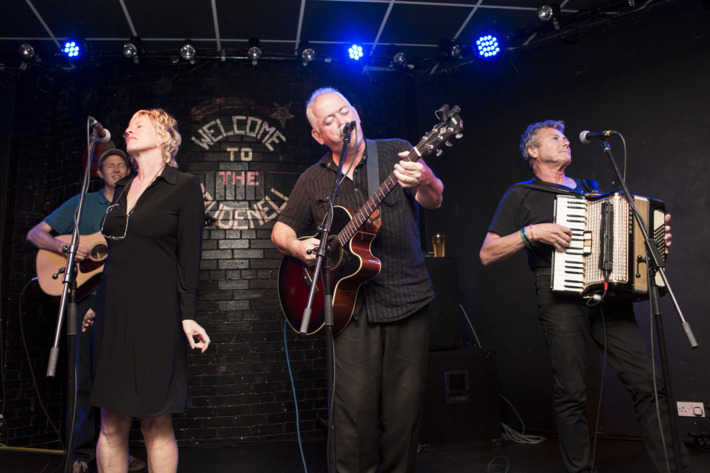 LEEDS, UNITED KINGDOM - AUGUST 06: Sally Timms, Jon Langford and Rico Bell of The Mekons perform on stage at Brudenell Social Club on August 6, 2014 in Leeds, United Kingdom. (Photo by Andrew Benge/Redferns via Getty Images)