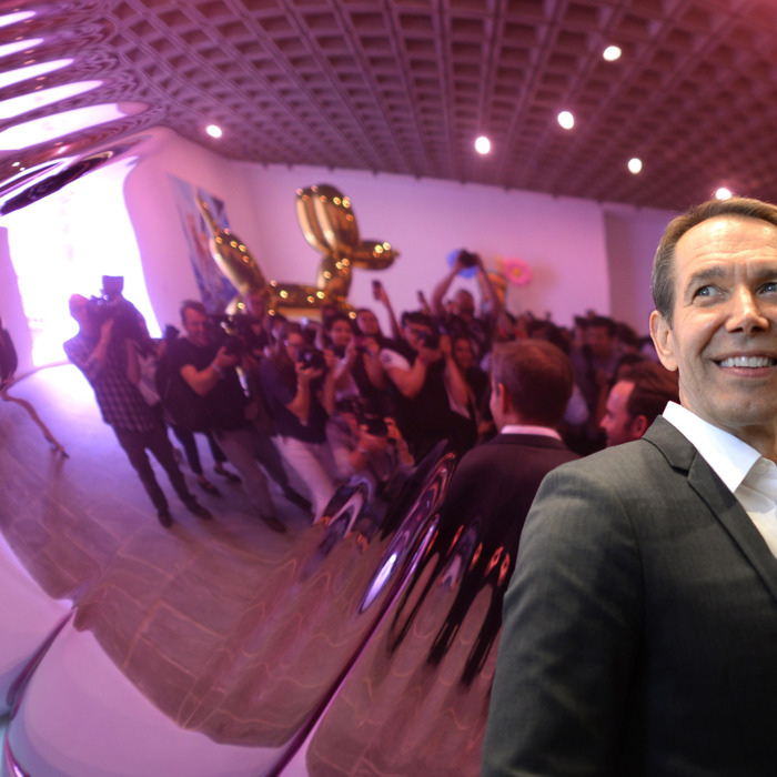 Artist Jeff Koons poses next to one of his sculptures during a press preview of